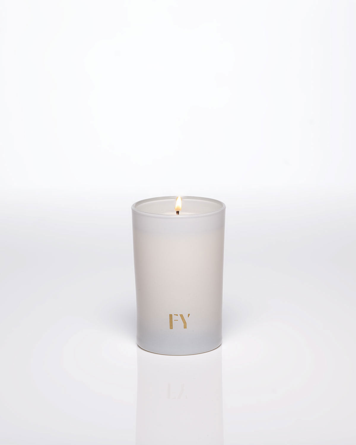 Lit FREE YOURSELF 4oz candle in FEU vessel
