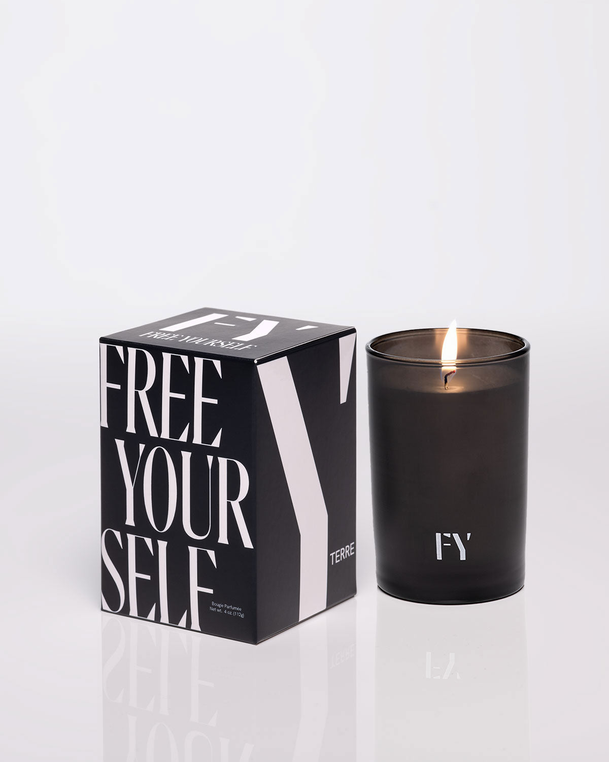 FREE YOURSELF 4oz TERRE candle in lit glass vessel