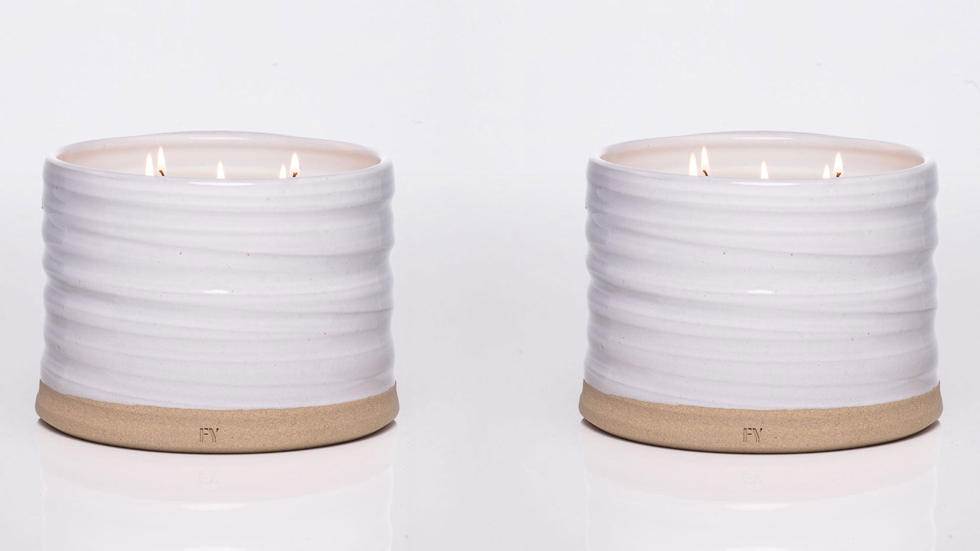 Two white ceramic candles