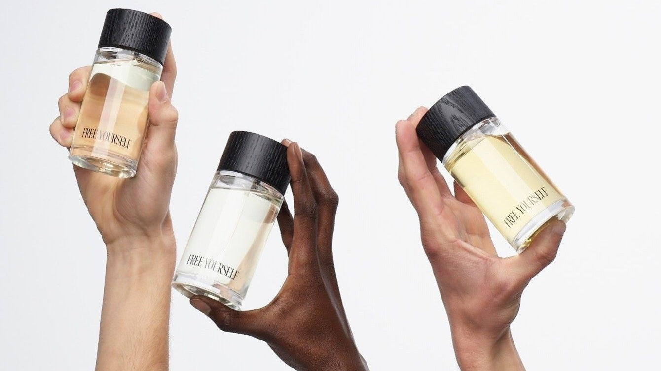 Hands holding perfume bottles