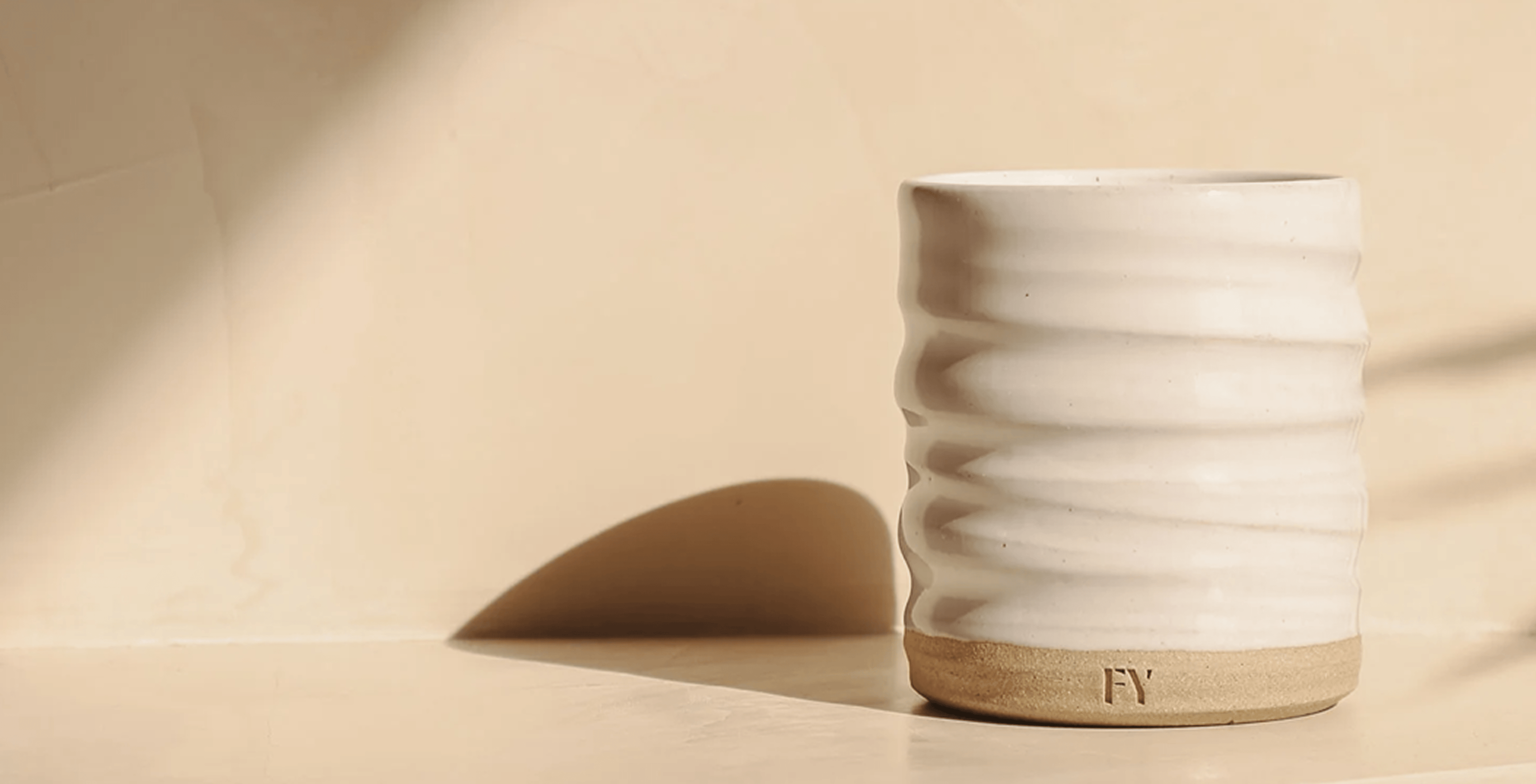 White ceramic candle holder with textured design