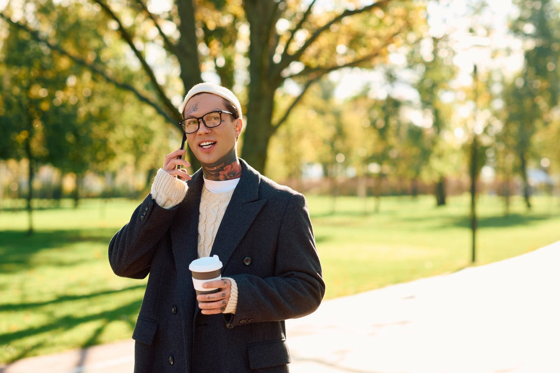 Best fall perfumes with cozy autumn outfit and coffee walk through a sunlit park