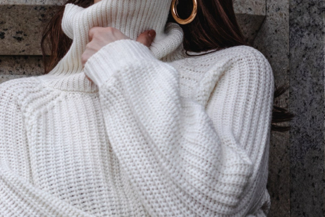 Best winter fragrances with cozy cream turtleneck sweater and cold-weather fashion styling