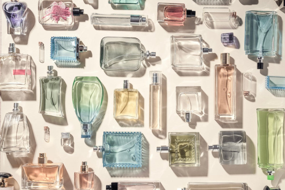 Flat lay of assorted fragrance bottles, representing eau de toilette vs perfume options