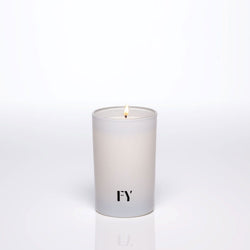 Lit FREE YOURSELF 4oz AIR candle in glass vessel