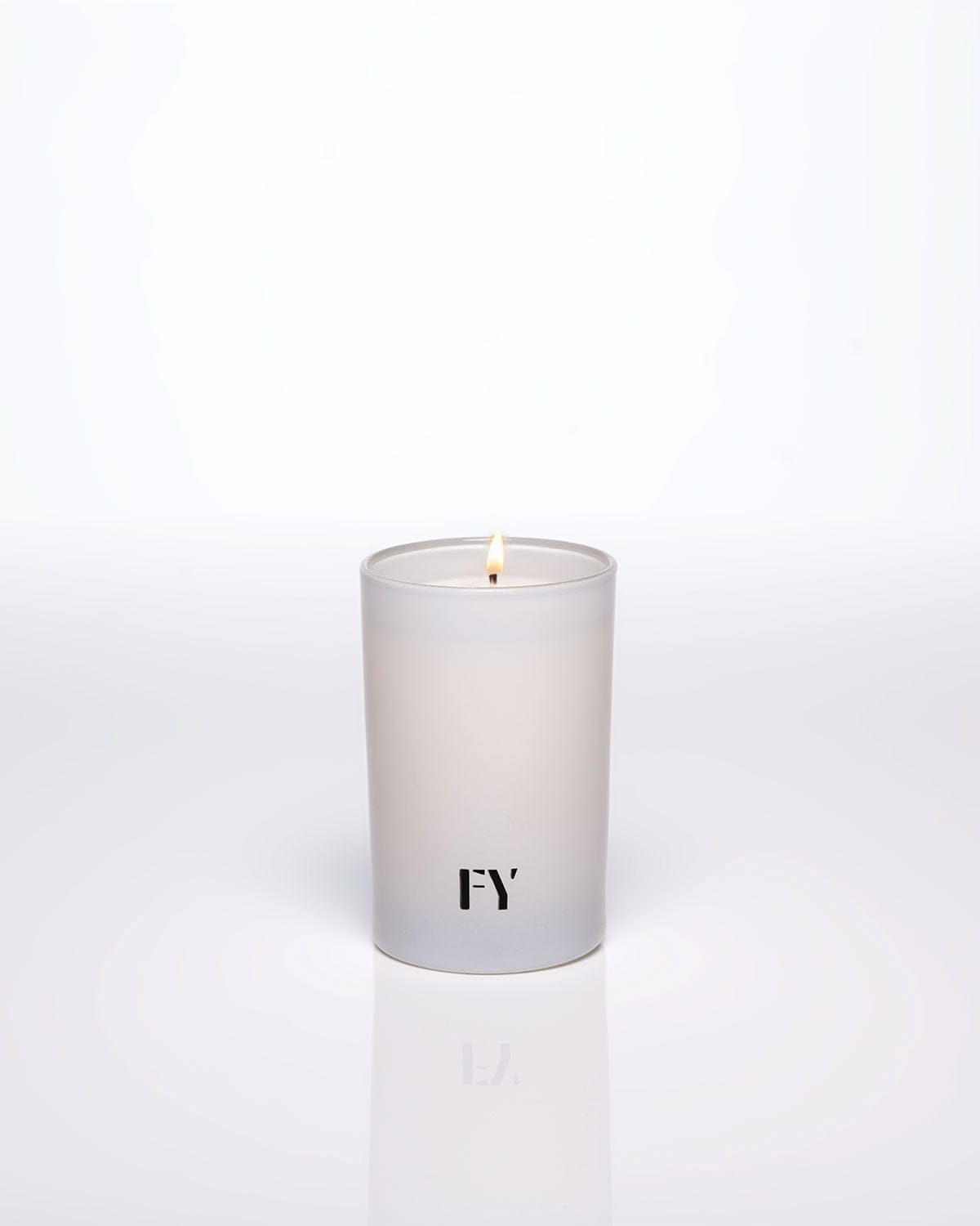 Lit FREE YOURSELF 4oz AIR candle in glass vessel