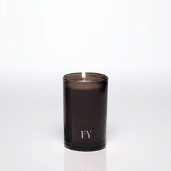 Lit 4oz FREE-YOURSELF EAU candle in dark vessel