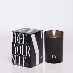 FREE YOURSELF 4oz TERRE candle in lit glass vessel