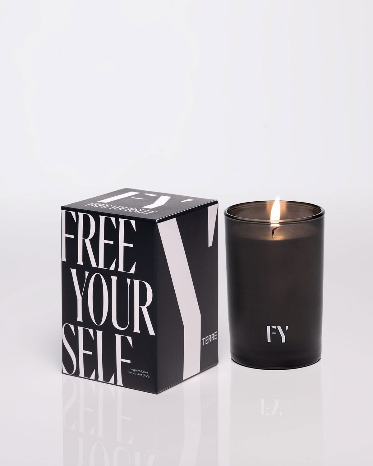 FREE YOURSELF 4oz TERRE candle in lit glass vessel