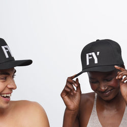 Two people wearing black FY hats.