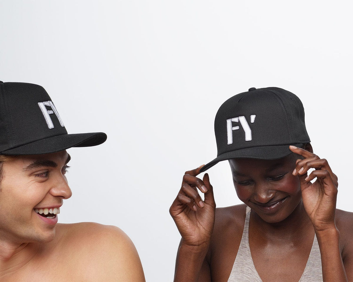 Two people wearing black FY hats.