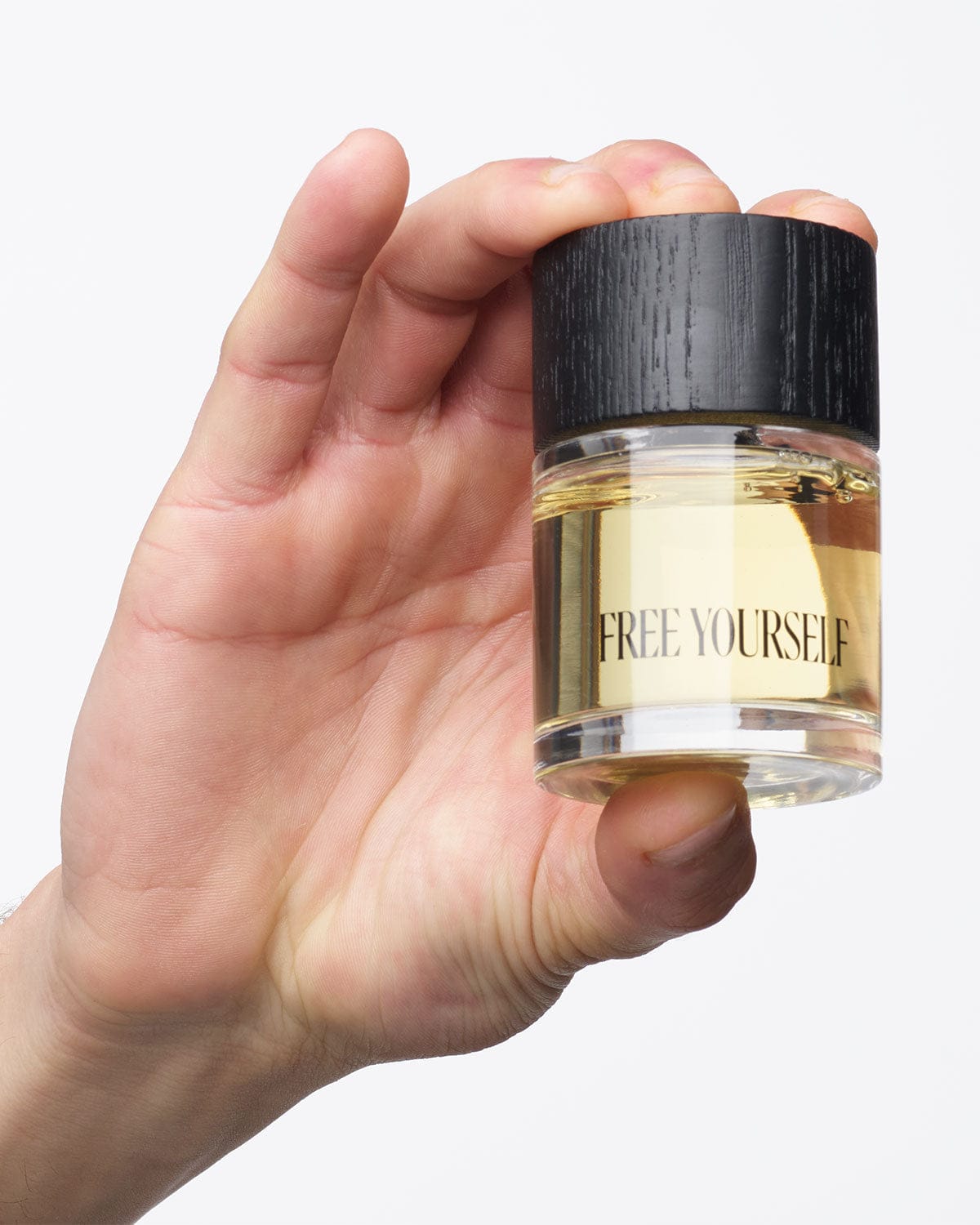 FREE YOURSELF Models 50ml perfume bottle held in hand