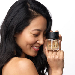 Woman holding FREE YOURSELF perfume 50ml