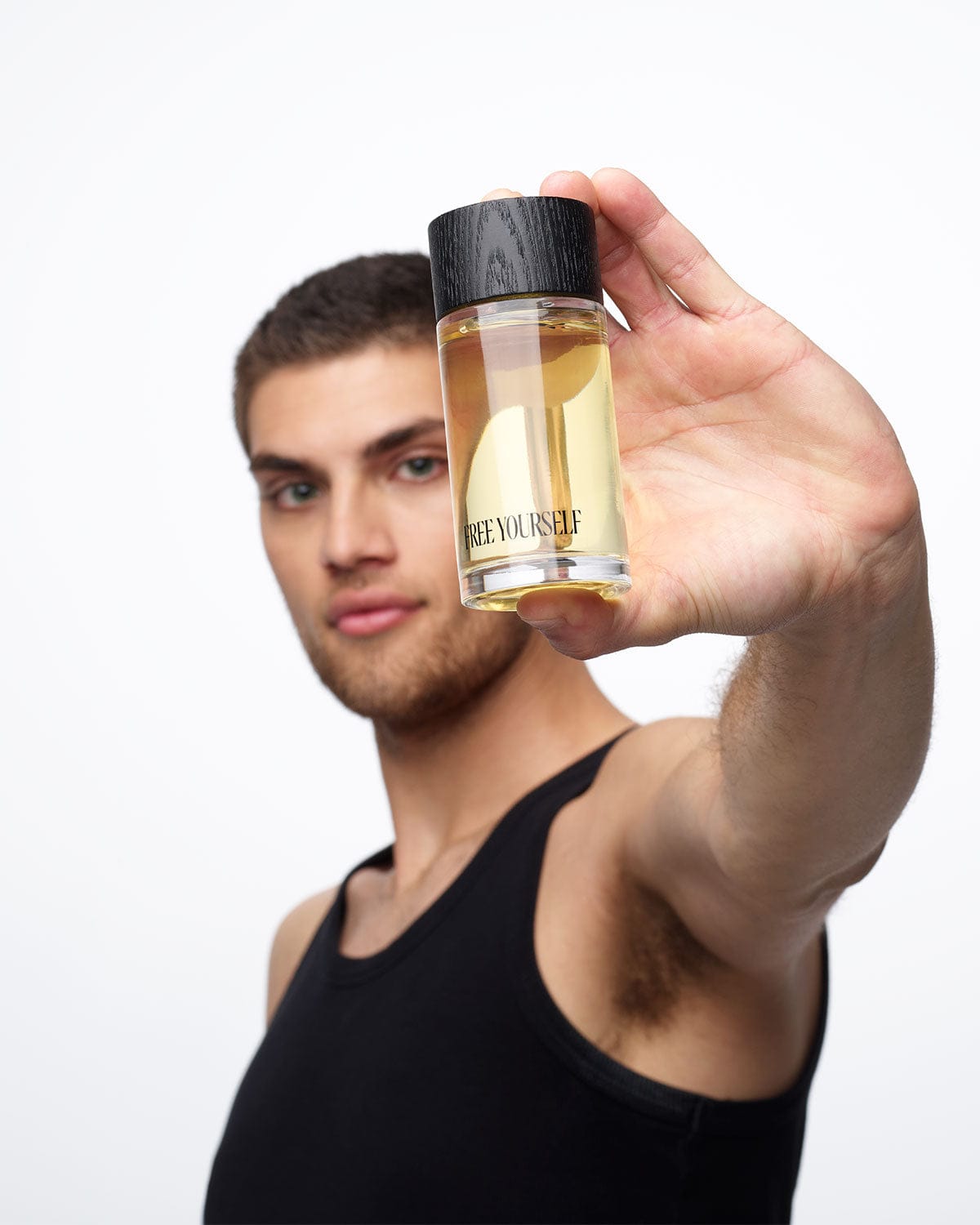 Man holding FREE YOURSELF 100ml EDP fragrance bottle