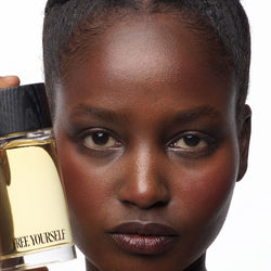 Free Yourself 100ml EDP bottle held by model