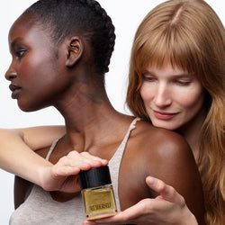 Two women holding Free Yourself 50ml EDP bottle